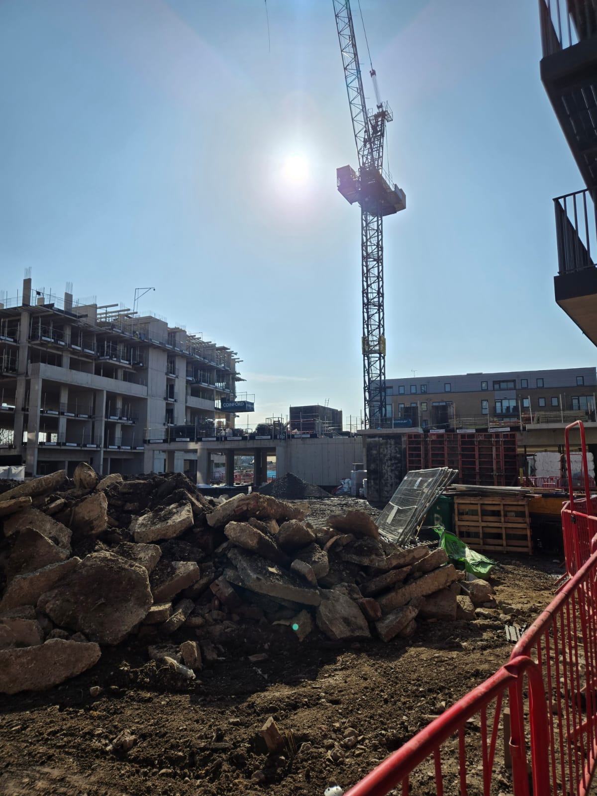 Residential development exterior showing managed apartment buildings and active access routes.